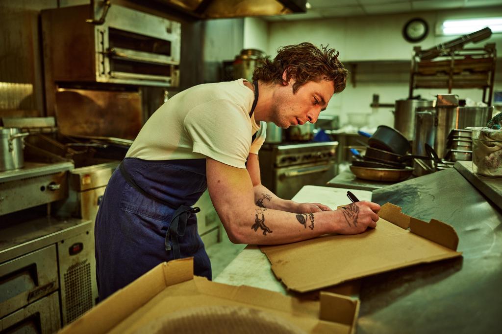 Jeremy Allen White on "The Bear" writing on a counter. 