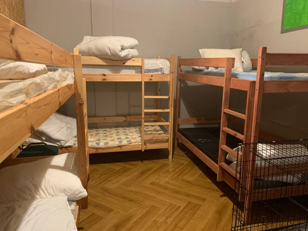 Makeshift beds at the shelter are separated by walls and concrete.