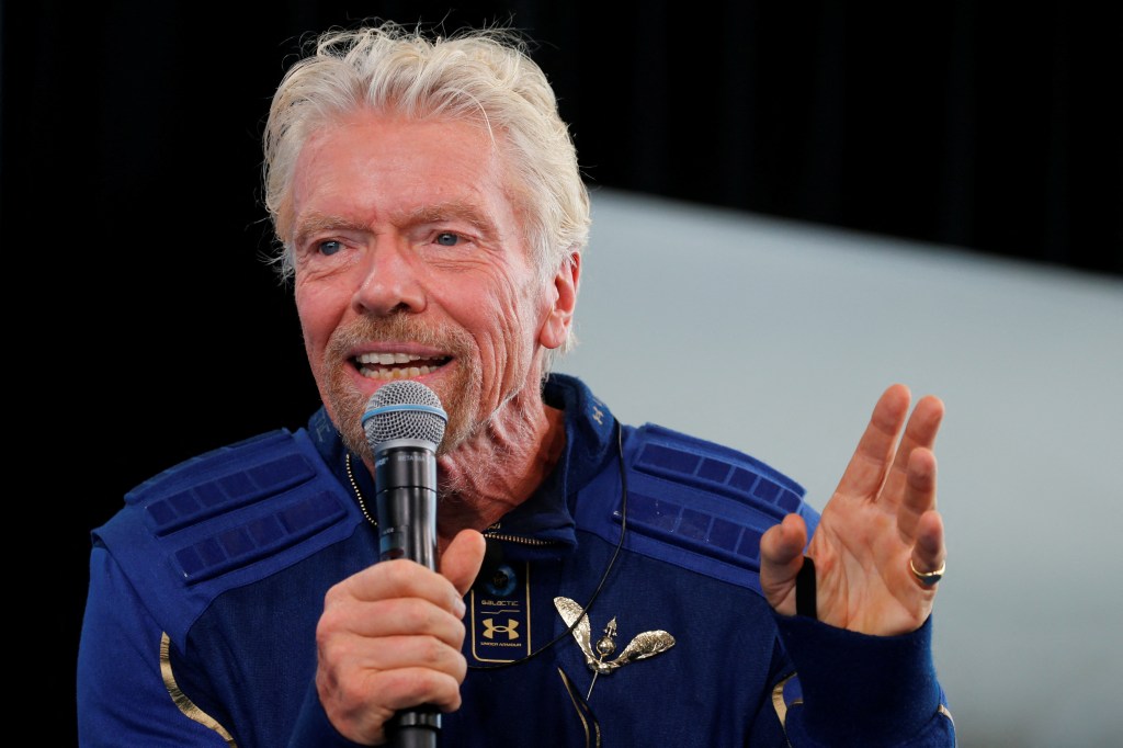 Billionaire entrepreneur Richard Branson wears his astronaut's wings at a news conference.