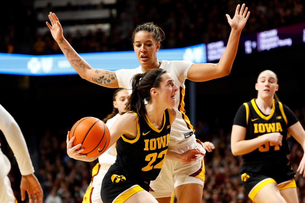 Caitlin Clark driving to the basket against Ayianna Johnson in a basketball game between Iowa Hawkeyes and Minnesota Golden Gophers.