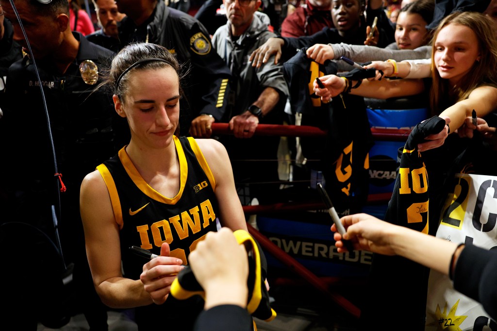 Caitlin Clark signing autographs for fans after the Iowa's win at Williams Arena, Minneapolis, Minnesota in Feb 2024.