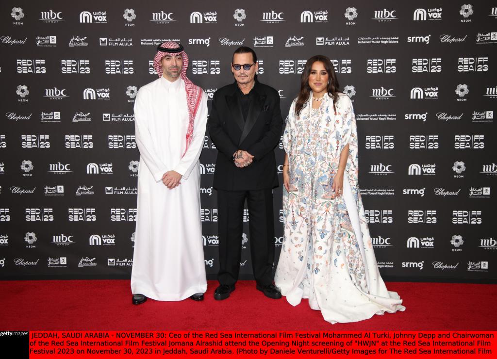 Ceo of the Red Sea International Film Festival Mohammed Al Turki, Johnny Depp and Chairwoman of the Red Sea International Film Festival Jomana Alrashid smiling. 