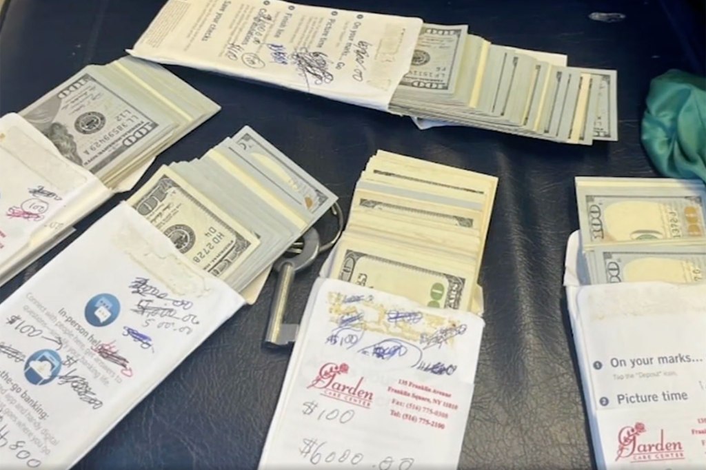 Several bank envelopes showing their contents of numerous $100 bills