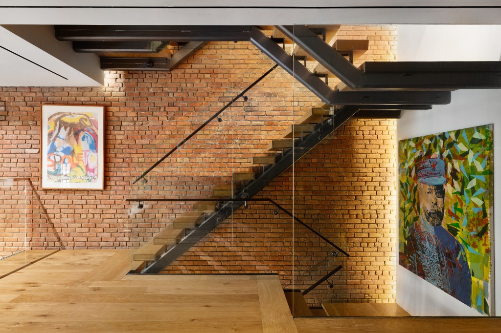 A grand staircase connects the townhouse's levels.