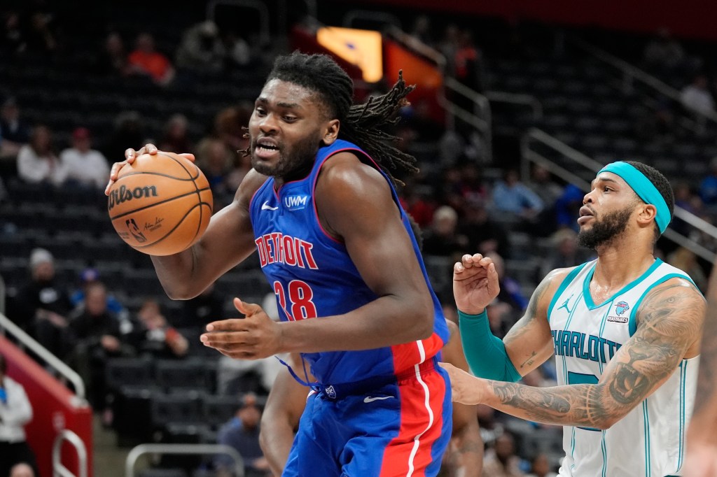 Pistons center Isaiah Stewart (28) grabs a rebound next to Charlotte Hornets forward Miles Bridges