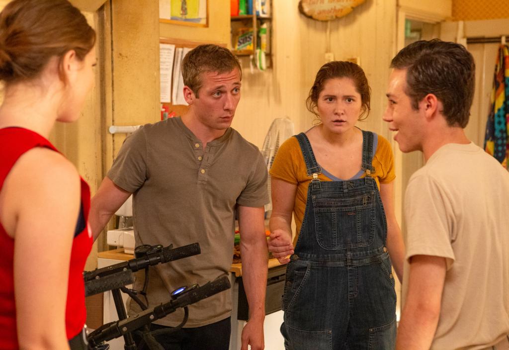 Jeremy Allen White, Emma Kenney, and Ethan Cutkosky on "Shameless" standing in a group looking worried. 