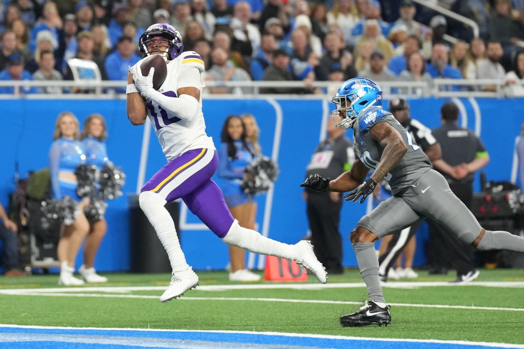 Justin Jefferson #18 of the Minnesota Vikings scores a touchdown during the third quarter in the game against the Detroit Lions at Ford Field on January 7, 2024 in Detroit, Michigan. 