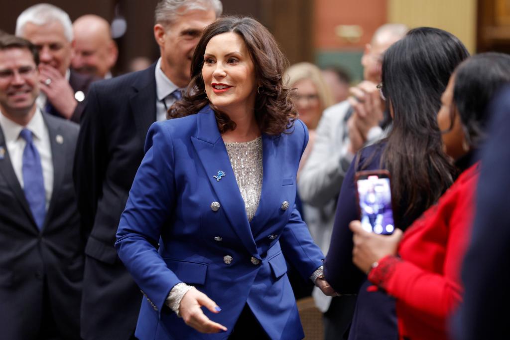 Gretchen Whitmer greets legislators and guests in House chambers before delivering State of the State address in Lansing, Michigan.