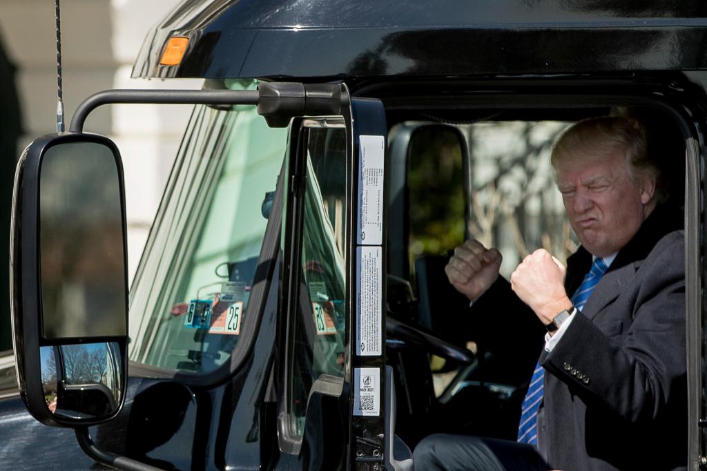 President Donald Trump gestures while sitting in an 18-wheeler truck while meeting with truckers and CEOs regarding healthcare on the South Lawn of the White House.