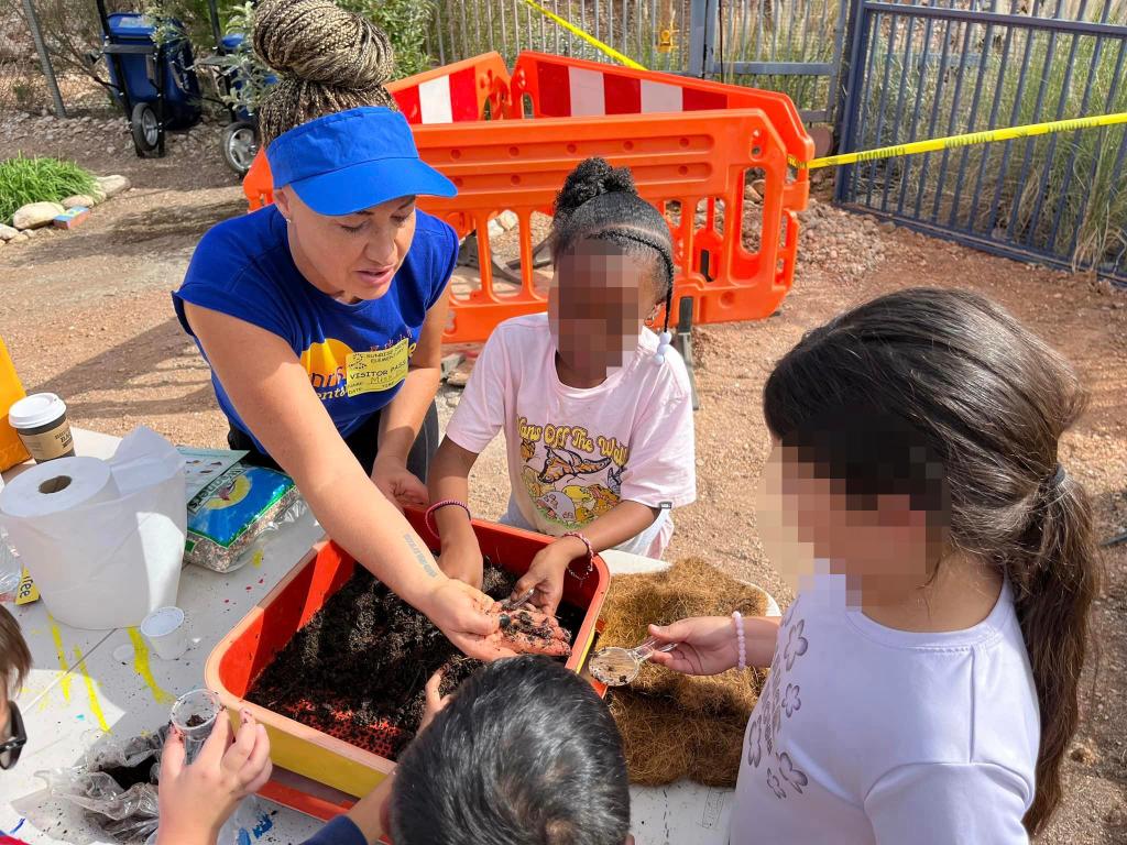 Dolezal is pictured helping students at the elementary school.