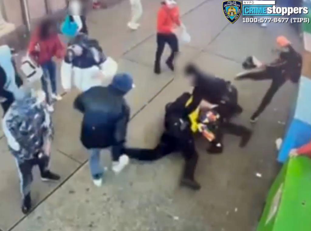 Video of attack on police in Times Square shows a suspect in red hoodie