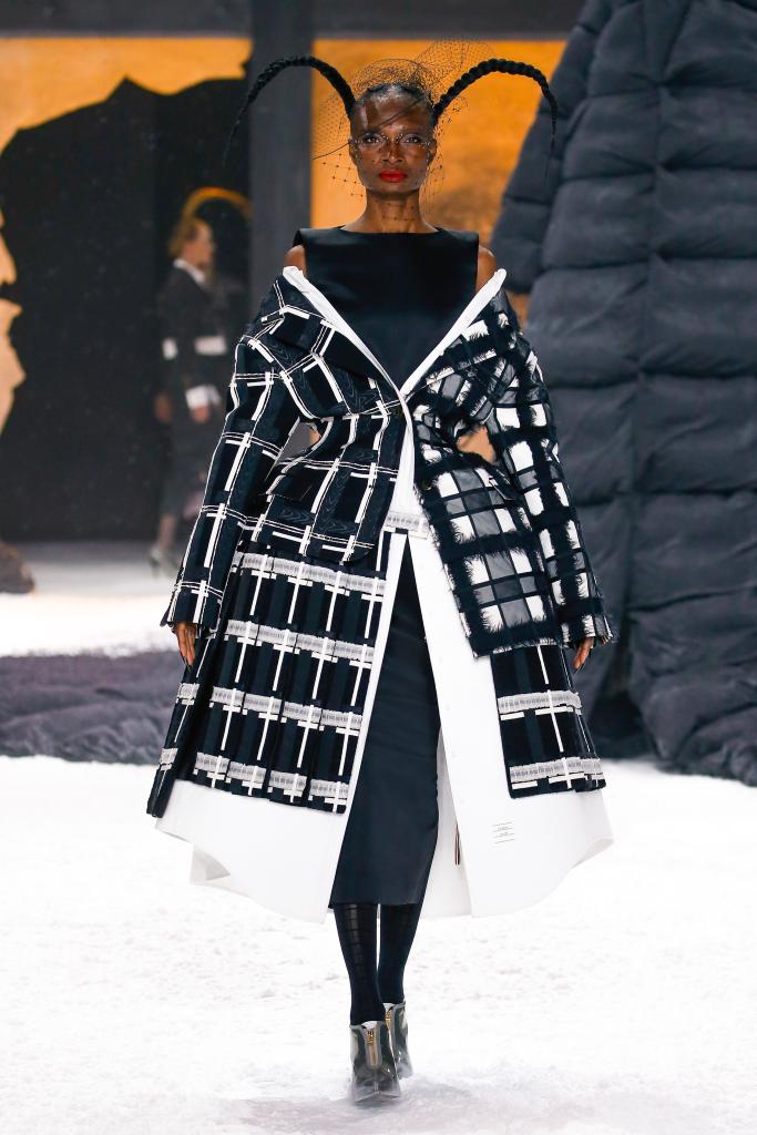 A model at Thom Browne wears a gigantic plaid, black and white coat