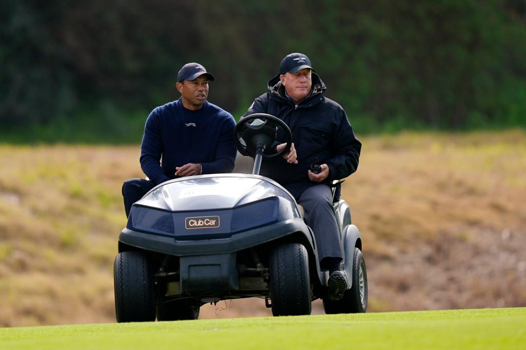 Tiger Woods (L.) is driven off the course during the Genesis Invitational on Feb. 16, 2024. 