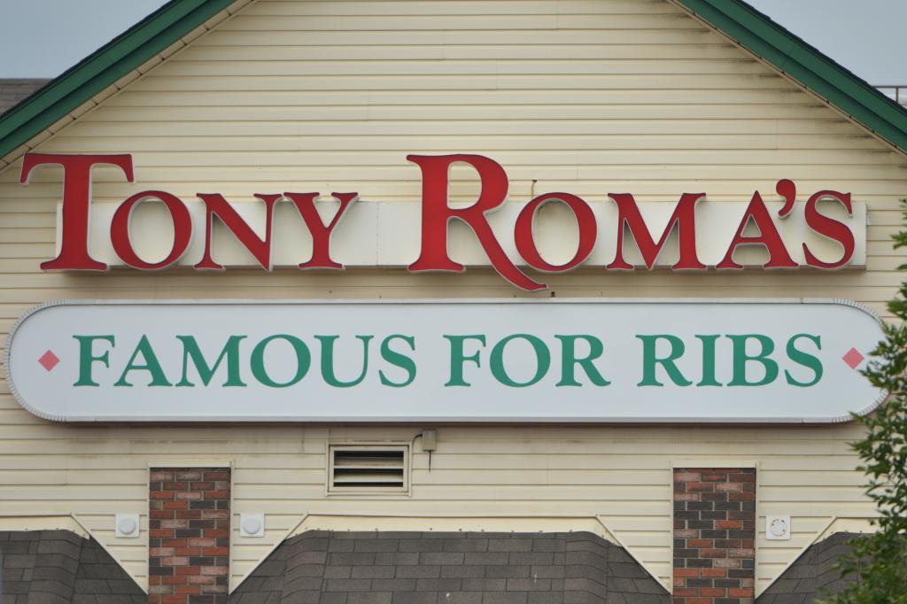 Tony Roma's logo on a building in Edmonton, Alberta, with blue sky in the background.