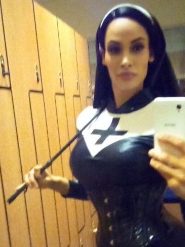 Woman in leather corset and nun's habit