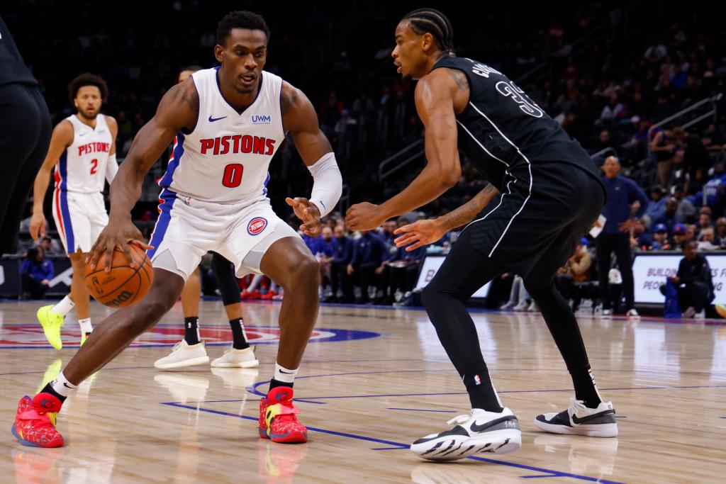 Detroit Pistons center Jalen Duren (0) dribbles defended by Brooklyn Nets center Nic Claxton