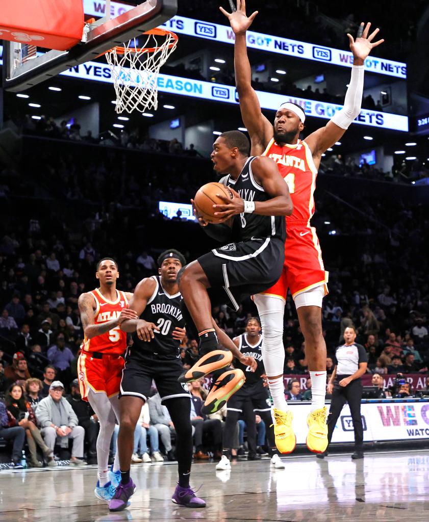 Lonnie Walker IV #8 of the Brooklyn Nets goes up for a shot as Bruno Fernando #24 of the Atlanta Hawks jumps to defend during the first half.