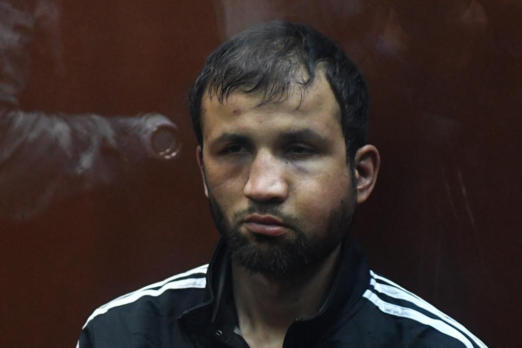  A man suspected of taking part in the attack of a concert hall that killed 137 people, the deadliest attack in Europe to have been claimed by the Islamic State jihadist group, sits inside the defendant cage as he waits for his pre-trial detention hearing at the Basmanny District Court in Moscow on March 24.