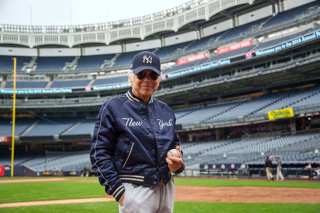 Ralph Lauren in Yankee stadium wearing a baseball uniform.