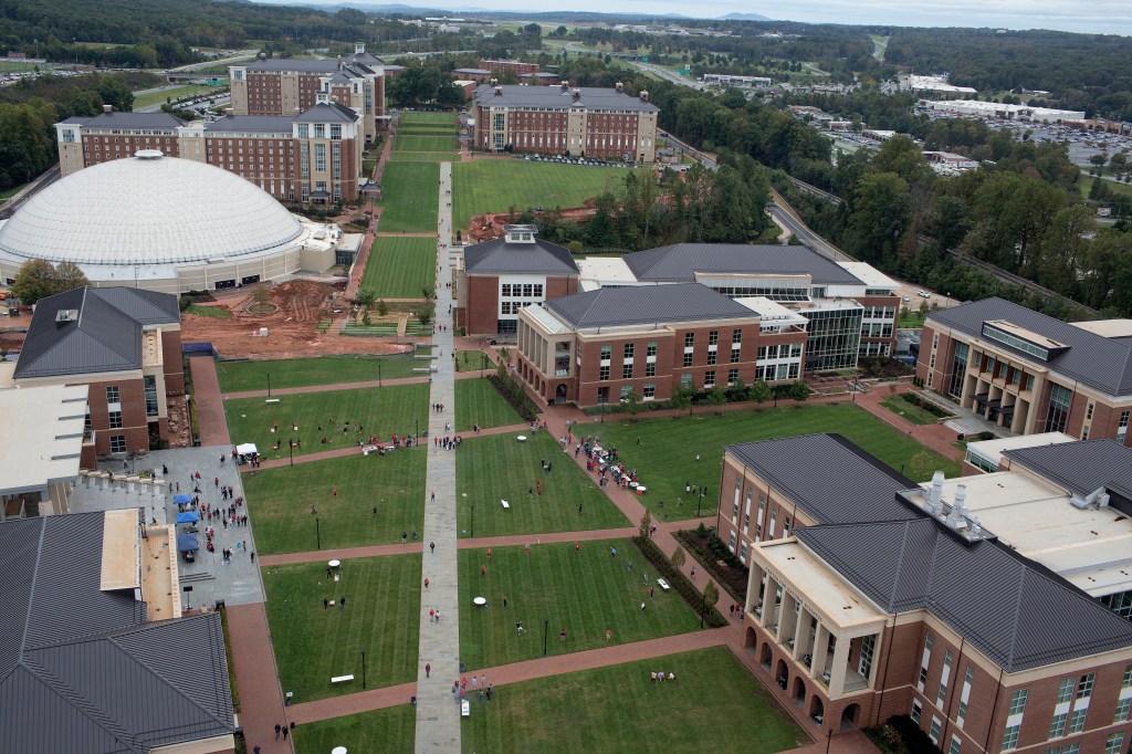 A crowd of students gathered together on a grassy campus lawn at Liberty University, Lynchburg. (Photo by Andrew Lichtenstein/Corbis via Getty Images)