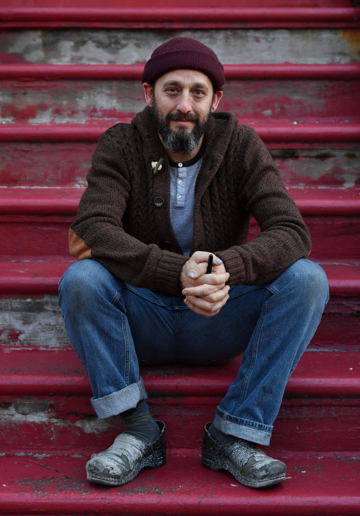 Rusty Zimmerman sitting on steps. 