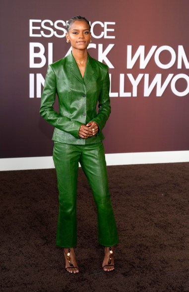 Letitia Wright posing in a green suit at 2024 Essence Black Women in Hollywood Awards at Academy Museum in Los Angeles.