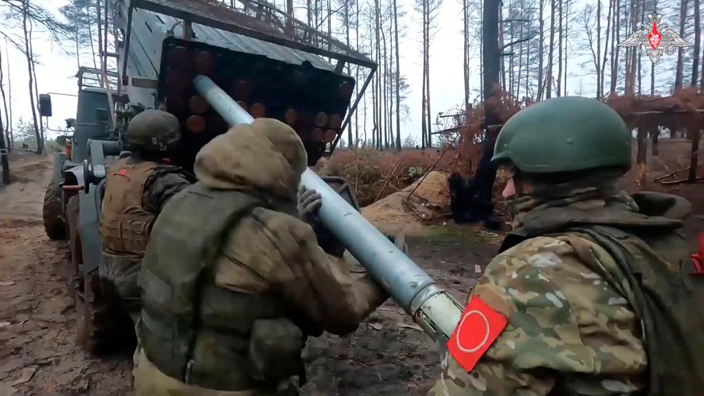 In this photo taken from video and released by Russian Defense Ministry Press Service on Thursday, Feb. 8, 2024, Russian soldiers load a rocket into a Grad rocket launcher on a mission at an undisclosed location in Ukraine