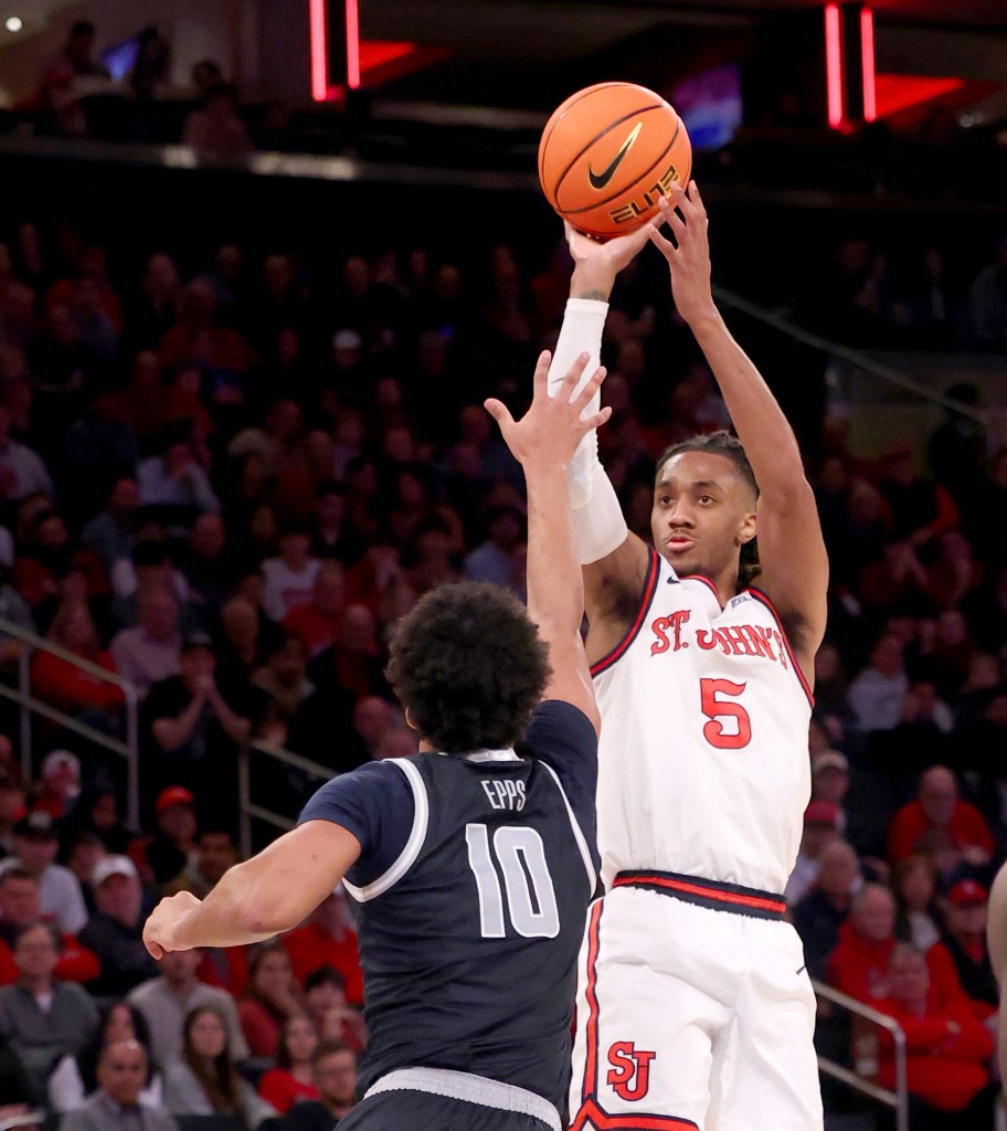 Daniss Jenkins #5 of the St. John's Red Storm puts up a shot over Jayden Epps