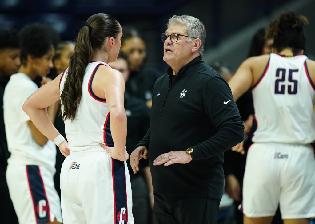 UConn Huskies head coach Geno Auriemma talks with guard Nika Muhl (10) from the sideline as they take on the Jackson State Lady Tigers at Harry A. Gampel Pavilion. 