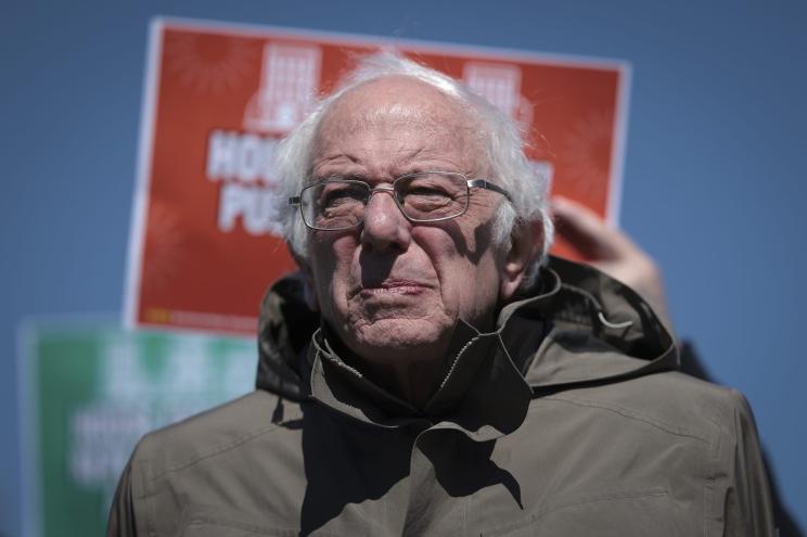 Sen. Bernie Sanders listens as Rep. Alexandria Ocasio-Cortez speaks at a press conference outside the U.S. Capitol March 21, 2024 in Washington, DC.