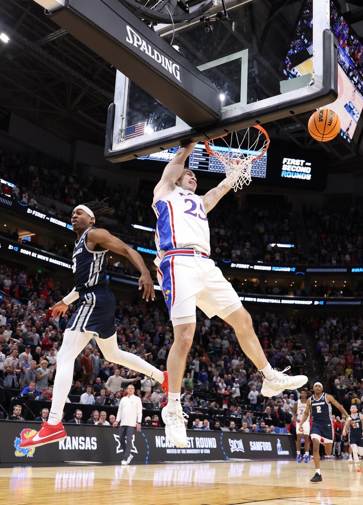 A.J. Staton-McCray #5 of the Samford Bulldogs is called for a foul on Nicolas Timberlake #25 of the Kansas Jayhawks with 14 seconds left during the second half in the first round of the NCAA Men's Basketball Tournament at Delta Center on March 21, 2024 in Salt Lake City, Utah.