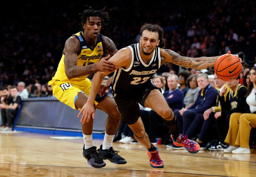 Devin Carter #22 of the Providence Friars dribbles against Zaide Lowery #10 of the Marquette Golden Eagles.