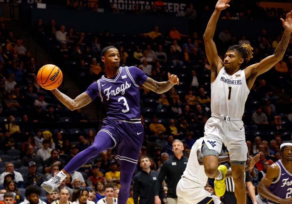 Avery Anderson III #3 of the TCU Horned Frogs looks to pass against Noah Farrakhan #1 of the West Virginia Mountaineers in the first half at the WVU Coliseum.