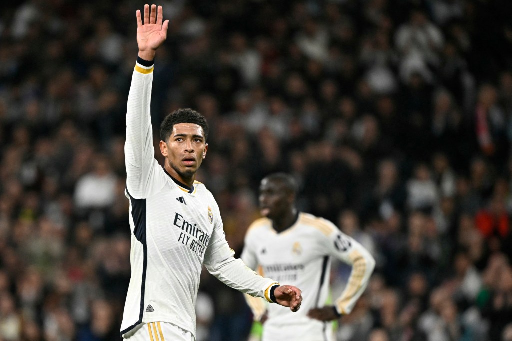 English footballer Jude Bellingham waves in a white uniform during Real Madrid CF versus RB Leipzig match at Santiago Bernabeu stadium in Madrid.
