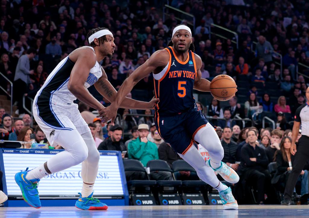 Precious Achiuwa #5 of the New York Knicks drives to the basket as Wendell Carter Jr. #34 of the Orlando Magic defends