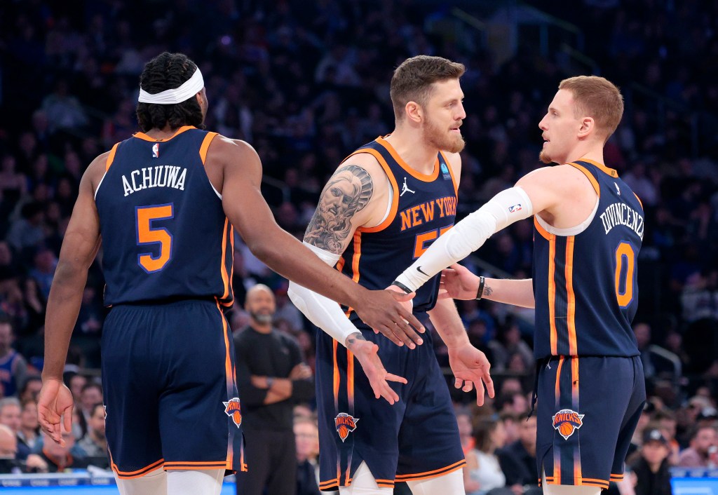 Isaiah Hartenstein #55 of the New York Knicks greets Precious Achiuwa #5 of the New York Knicks and Donte DiVincenzo