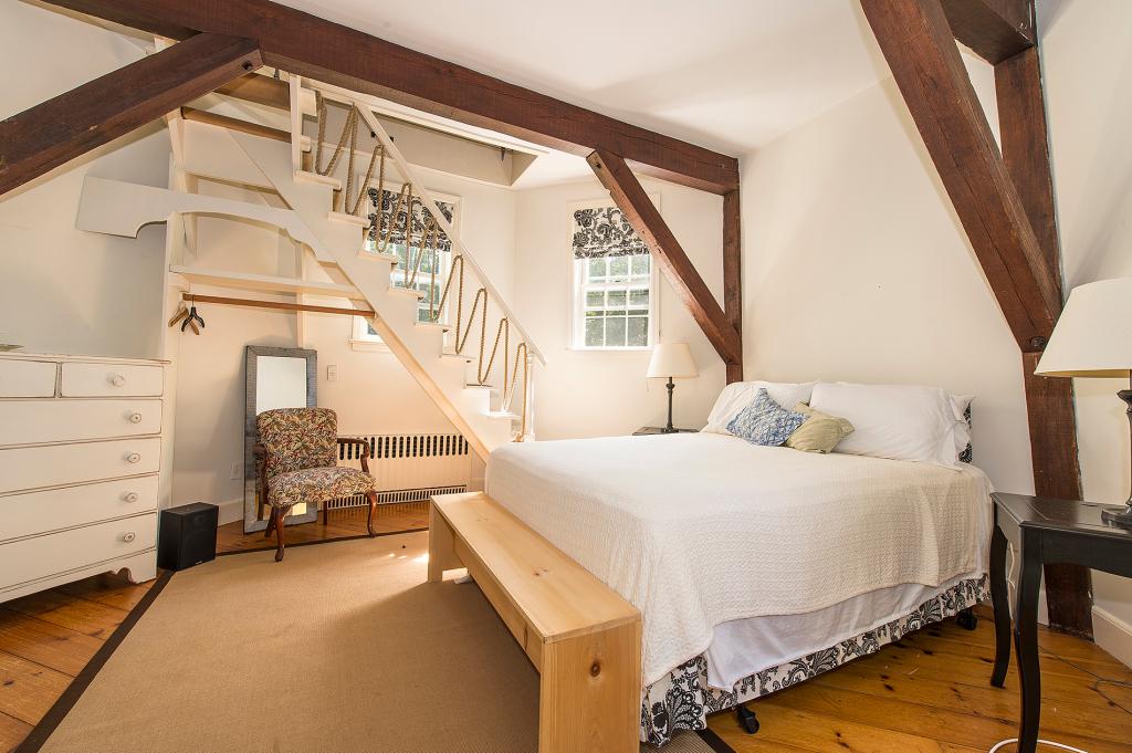 A charming bedroom is inside the converted windmill.