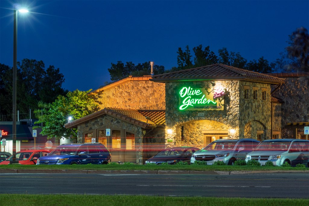 Olive Garden restaurant exterior with parked cars.