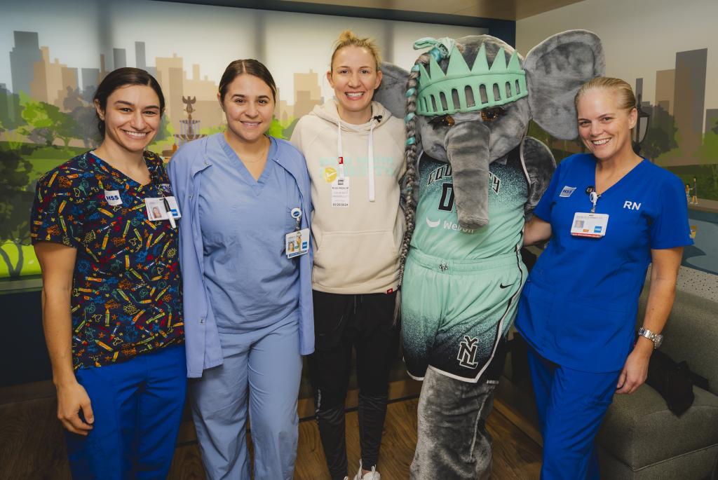 Courtney Vandersloot poses for a picture with nurses and staff members at the Lerner Children's Pavilion on Thursday.