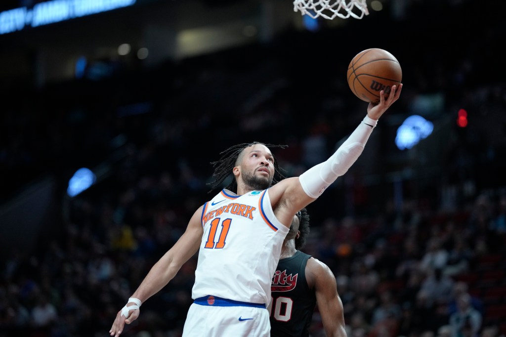 Jalen Brunson #11 of the New York Knicks shoots the ball against Scoot Henderson #00 of the Portland Trail Blazers during the second half.