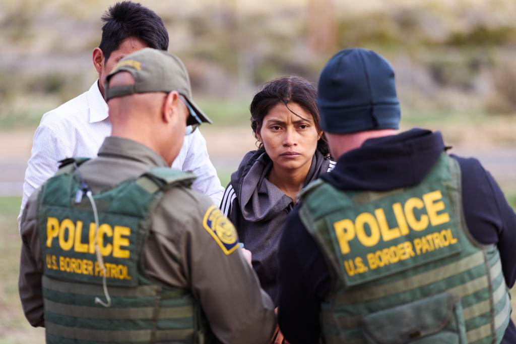 Migrants turned themselves into US Customs and Border Protection officers at a makeshift camp after crossing the U.S.-Mexico border wall. 