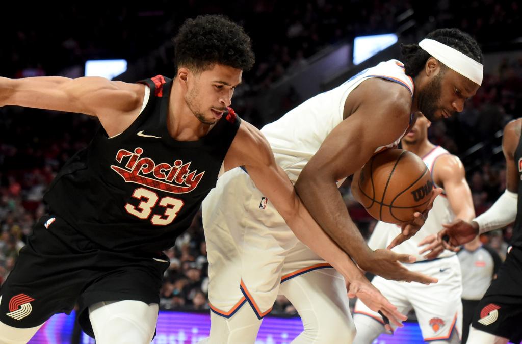 Precious Achiuwa (right), who scored four points and grabbed seven rebounds, battles Toumani Camara for the ball during the Knicks' 105-93 win over the Trail Blazers.