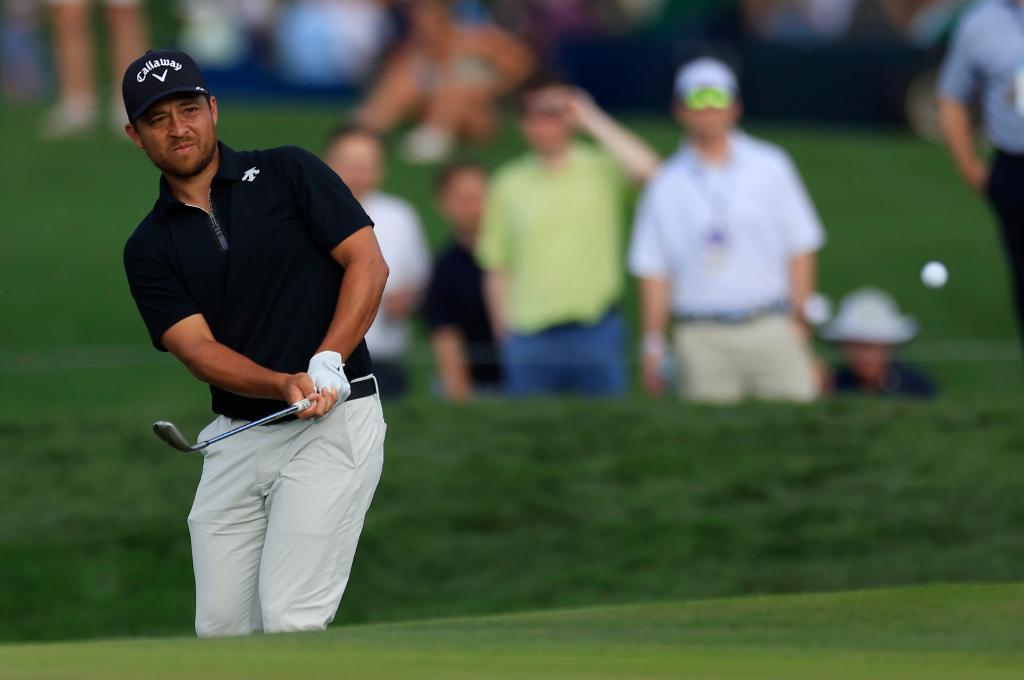 Xander Schauffele, who has a one-shot lead, hits a chip shot on the 11th hole during the third round of the Players Championship. 