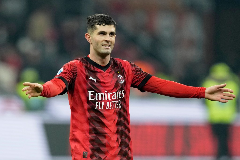 Christian Pulisic smiles, wearing AC Milan's red jersey, after scoring the goal in their 1-0 victory against Sassuolo in the Italy Soccer Serie A.