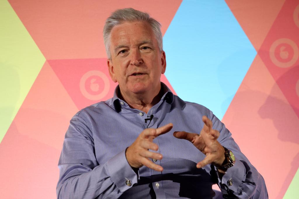 Adrian Hallmark, Chairman and CEO of Bentley Motors Ltd, sitting in a chair at The Innovation Factory Stage event, during Advertising Week Europe in London