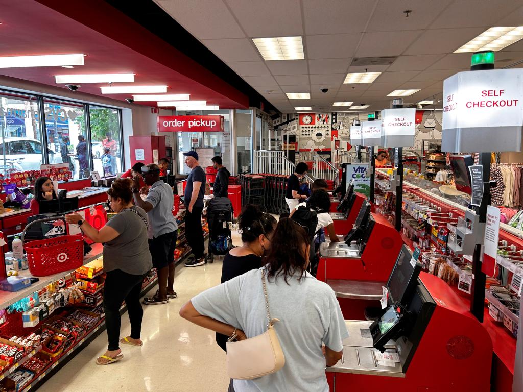 Customers scanning items at self-checkout at a Target store.