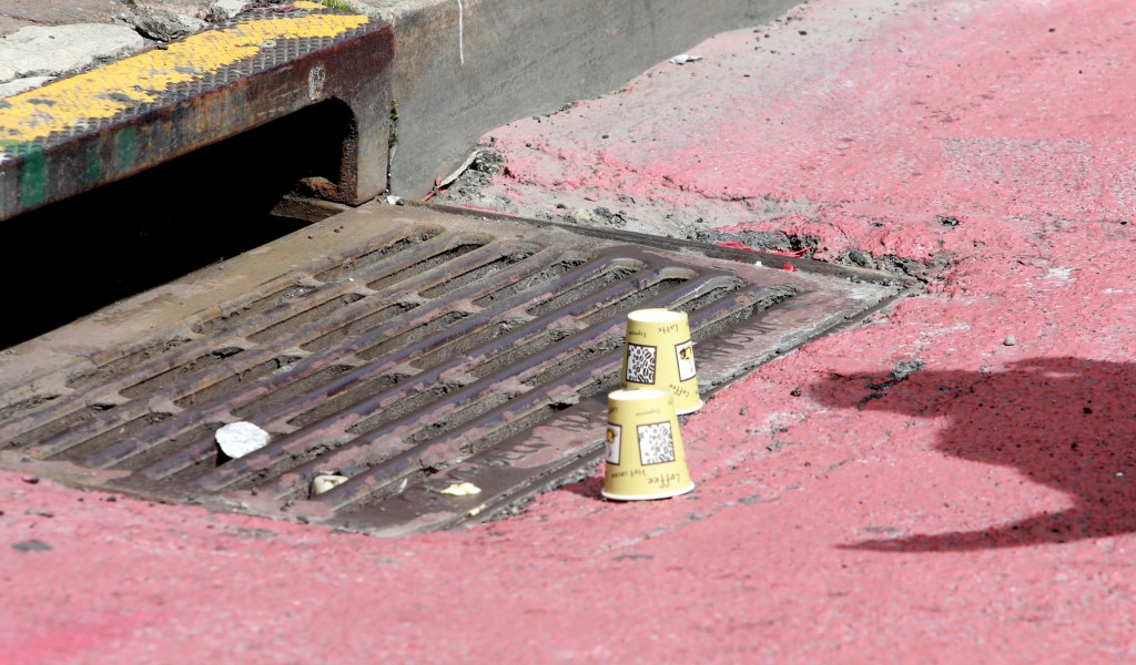 A photo of paper cups marking where the shell casings were recovered.