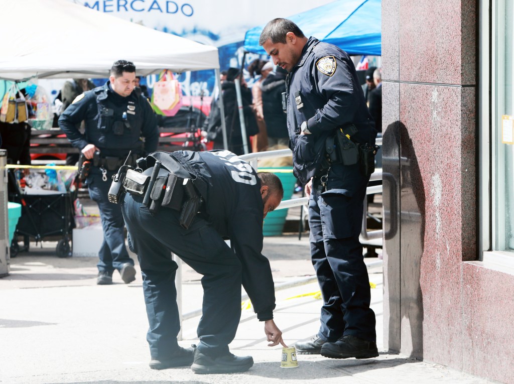 A photo of cops marking a shellcasing