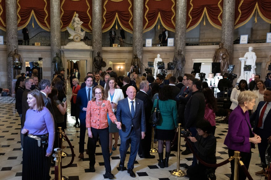 Former Rep. Gabby Giffords and Senator Mark Kelly walk to House Chamber ahead of President Biden's State of The Union Address on Capitol Hill.