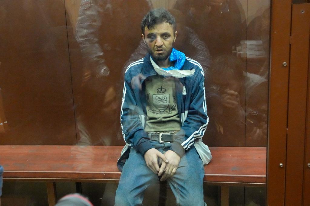 Dalerdzhon Mirzoyev, a suspect in the Crocus City Hall shooting on Friday sits in a glass cage in the Basmanny District Court in Moscow, Russia.